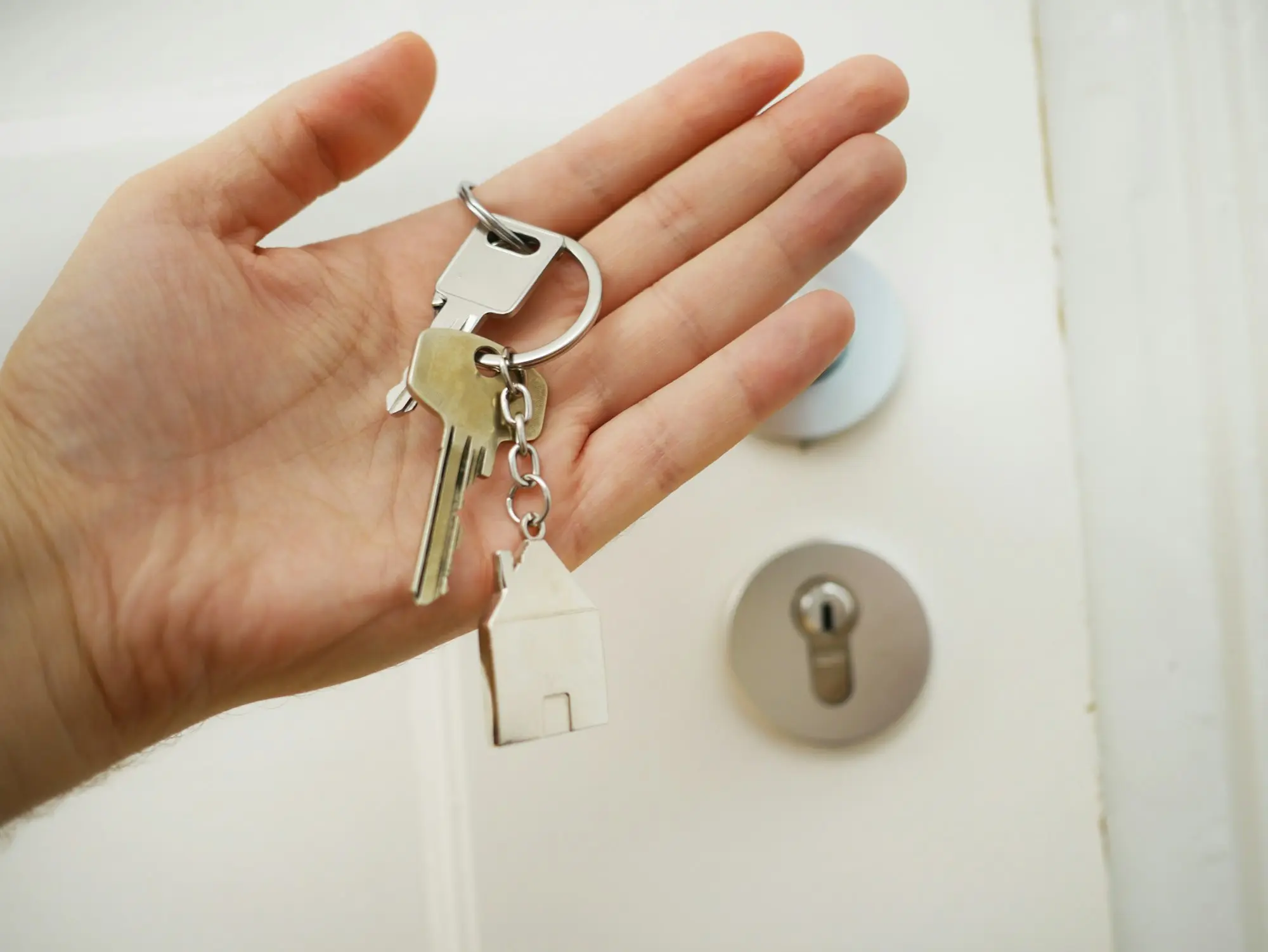 Hand holding the keys to a newly bought business