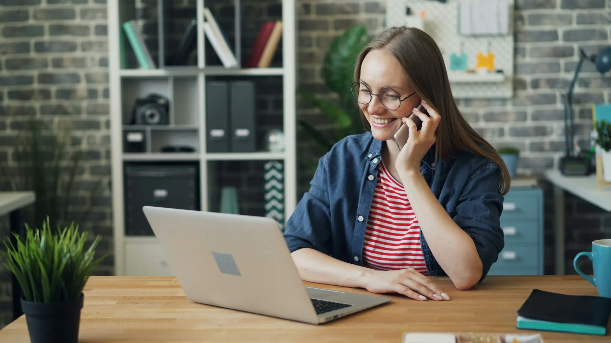 Business owner on the phone to a lender at her desk