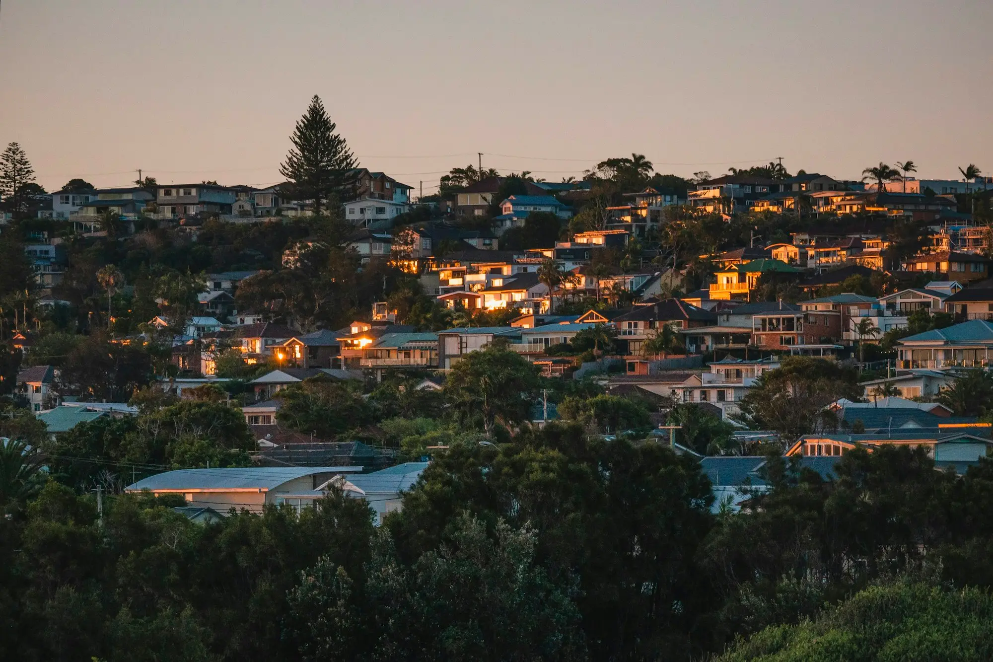 Suburban houses on a hillside in Sydney at dusk